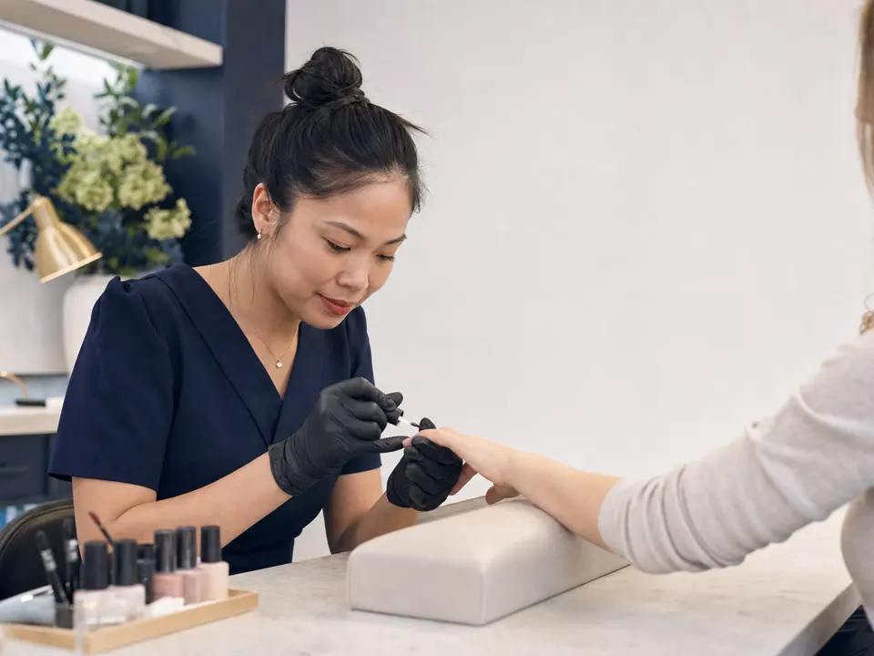 Nail technician preparing a manicure in a modern salon